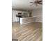 Open-concept living area boasts pristine wood floors and a breakfast bar connecting it to the kitchen at 2260 Burdett Ridge Dr, South Fulton, GA 30349