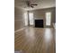 Light-filled living room boasts wood floors, a cozy fireplace, and access to the outdoors at 2260 Burdett Ridge Dr, South Fulton, GA 30349
