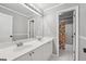 Bright bathroom featuring double vanity, large mirror, and shower with patterned curtain at 6448 Mobilis Ct, Sugar Hill, GA 30518