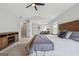 Large main bedroom featuring sitting area, vaulted ceilings, and wood furnishings at 6448 Mobilis Ct, Sugar Hill, GA 30518