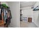 Walk-in closet featuring shelving, hanging racks, and attic access at 6448 Mobilis Ct, Sugar Hill, GA 30518