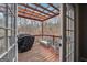 Outdoor deck with a wooden pergola and covered grill at 6448 Mobilis Ct, Sugar Hill, GA 30518