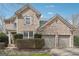 Charming brick home featuring a two-car garage and well-maintained landscaping at 6448 Mobilis Ct, Sugar Hill, GA 30518