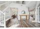 Spacious foyer with hardwood floors, staircase, and dining room view at 6448 Mobilis Ct, Sugar Hill, GA 30518