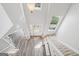 Bright foyer with staircase, hardwood floors, and natural light coming in from windows at 6448 Mobilis Ct, Sugar Hill, GA 30518