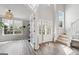 Foyer with wood flooring, natural light, and stairway at 6448 Mobilis Ct, Sugar Hill, GA 30518