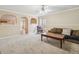 Cozy living room with comfortable carpet, decorative archways, and natural light at 6448 Mobilis Ct, Sugar Hill, GA 30518