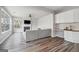 Open-concept living room features a fireplace, bright windows, seamless access to the kitchen, and modern decor at 6448 Mobilis Ct, Sugar Hill, GA 30518