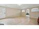 Bright living room featuring tile flooring, neutral walls, and an archway at 6448 Mobilis Ct, Sugar Hill, GA 30518