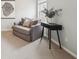Cozy sitting area with gray couch, desk, and large picture window at 6448 Mobilis Ct, Sugar Hill, GA 30518