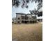 Brick home with a backyard featuring a large screened porch and open deck spaces for outdoor living and gatherings at 829 Artistry Way, Fairburn, GA 30213