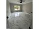 Bedroom featuring large window, neutral gray walls, recessed lighting, ceiling fan, and marble tile flooring at 829 Artistry Way, Fairburn, GA 30213