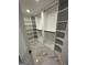 Walk-in closet with custom shelving and marble tile flooring provides ample storage space at 829 Artistry Way, Fairburn, GA 30213
