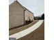 View along driveway, showing brick home with ample parking space and two-car garage at 829 Artistry Way, Fairburn, GA 30213