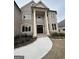 Close up of the brick home's entrance featuring stately columns and front walkway at 829 Artistry Way, Fairburn, GA 30213