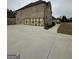 Angle view of a two-story brick home, highlighting the garage and driveway on an overcast day at 829 Artistry Way, Fairburn, GA 30213