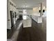 Open-concept kitchen features white cabinets, stainless steel appliances, and large island at 829 Artistry Way, Fairburn, GA 30213