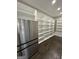 Large walk-in pantry with ample shelving and stainless steel refrigerator at 829 Artistry Way, Fairburn, GA 30213