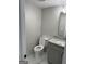 Cozy powder room with marble tile flooring, granite countertop, and neutral gray walls at 829 Artistry Way, Fairburn, GA 30213