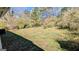 Spacious, grassy backyard with mature trees and partial shade from surrounding greenery at 4214 Canby Ln, Decatur, GA 30035