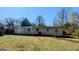 View of a backyard and home featuring a well-maintained lawn, and mature trees at 4214 Canby Ln, Decatur, GA 30035