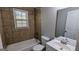 Updated bathroom featuring a tub, shower, white vanity, and light fixtures at 4214 Canby Ln, Decatur, GA 30035