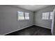 Bright bedroom featuring two windows, dark wood-look flooring, and neutral wall paint at 4214 Canby Ln, Decatur, GA 30035