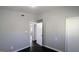 Bedroom featuring neutral paint, dark laminate flooring, and multiple access doors at 4214 Canby Ln, Decatur, GA 30035