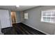 Comfortable bedroom featuring modern gray walls and newly installed, dark-stained laminate flooring throughout at 4214 Canby Ln, Decatur, GA 30035