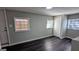 Cozy bedroom featuring modern gray walls and newly installed, dark-stained laminate flooring throughout at 4214 Canby Ln, Decatur, GA 30035