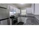 Well-appointed kitchen with white cabinets, granite countertops and stainless steel appliances at 4214 Canby Ln, Decatur, GA 30035