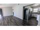 Open-concept living area showcasing newly installed, dark-stained laminate flooring and view into kitchen at 4214 Canby Ln, Decatur, GA 30035