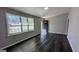 Inviting living room with bright windows, and newly installed, dark-stained laminate flooring throughout at 4214 Canby Ln, Decatur, GA 30035