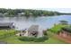 Picturesque backyard view of home, featuring a gazebo, lush greenery, and tranquil lake scenery at 1283 Heritage Dr, Villa Rica, GA 30180