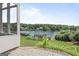 Backyard view featuring a lush lawn, garden, and serene lake scenery at 1283 Heritage Dr, Villa Rica, GA 30180