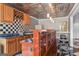 Stylish bar area with wooden cabinets, black and white tile backsplash, and a unique metal ceiling at 1283 Heritage Dr, Villa Rica, GA 30180