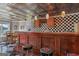 Finished bar area complete with wooden cabinets, seating, and stylish black and white checkered design at 1283 Heritage Dr, Villa Rica, GA 30180