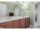 Bathroom featuring a double vanity, drawers, large mirror, and a door to the toilet at 1283 Heritage Dr, Villa Rica, GA 30180
