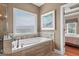 Bathroom features soaking tub with tile surround, large picture window and adjoins the main bedroom at 1283 Heritage Dr, Villa Rica, GA 30180