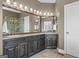Spacious bathroom with double vanity, tiled floor, shower and toilet with a decorative mirror and lighting at 1283 Heritage Dr, Villa Rica, GA 30180