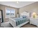 Bright bedroom with a white wooden bed frame, a blue striped blanket, and ample natural light at 1283 Heritage Dr, Villa Rica, GA 30180
