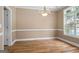 Bright dining room featuring hardwood floors, a chandelier, and a large window at 1283 Heritage Dr, Villa Rica, GA 30180