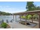 Covered dock features boat lift, outdoor furniture and a beautiful lake view at 1283 Heritage Dr, Villa Rica, GA 30180