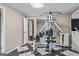 Bright and airy exercise room equipped with workout equipment and black and white checkered flooring at 1283 Heritage Dr, Villa Rica, GA 30180
