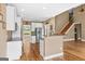Open kitchen featuring white cabinets, an island, hardwood floors, and stainless steel appliances at 1283 Heritage Dr, Villa Rica, GA 30180