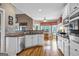 Bright kitchen with white cabinets, granite countertops, stainless appliances, hardwood floors, and breakfast nook at 1283 Heritage Dr, Villa Rica, GA 30180