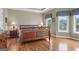 The main bedroom features hardwood floors, lake views, and large windows for plenty of light at 1283 Heritage Dr, Villa Rica, GA 30180