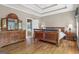 Well-lit primary bedroom with tray ceiling, wooden floors, en-suite bathroom and walk-in closet at 1283 Heritage Dr, Villa Rica, GA 30180