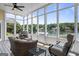 Cozy screened porch with comfortable seating and scenic lake views, perfect for relaxation at 1283 Heritage Dr, Villa Rica, GA 30180