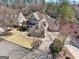 Aerial view of a beautiful home on a large lot with mature trees, a circular driveway, and meticulous landscaping at 210 Steeple Point Dr, Roswell, GA 30076